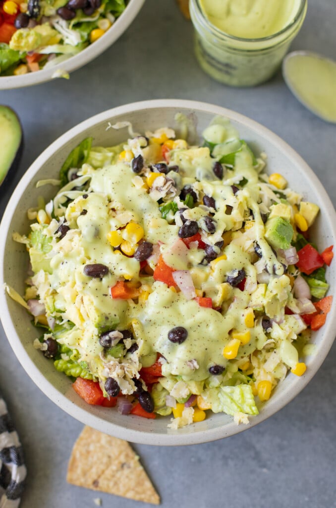 A close up of avocado ranch salad in a white bowl