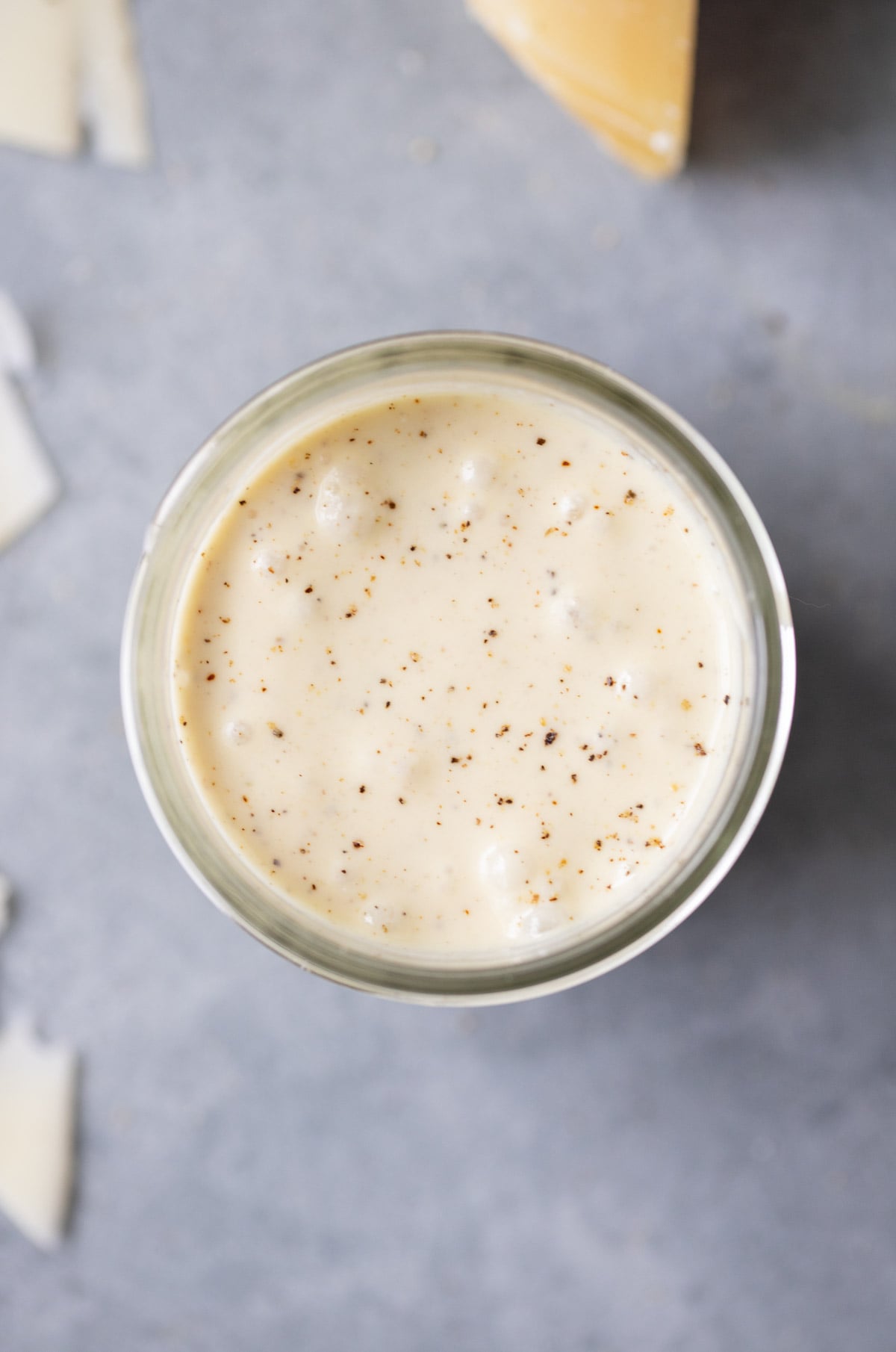 A close up of caesar salad dressing in a mason jar