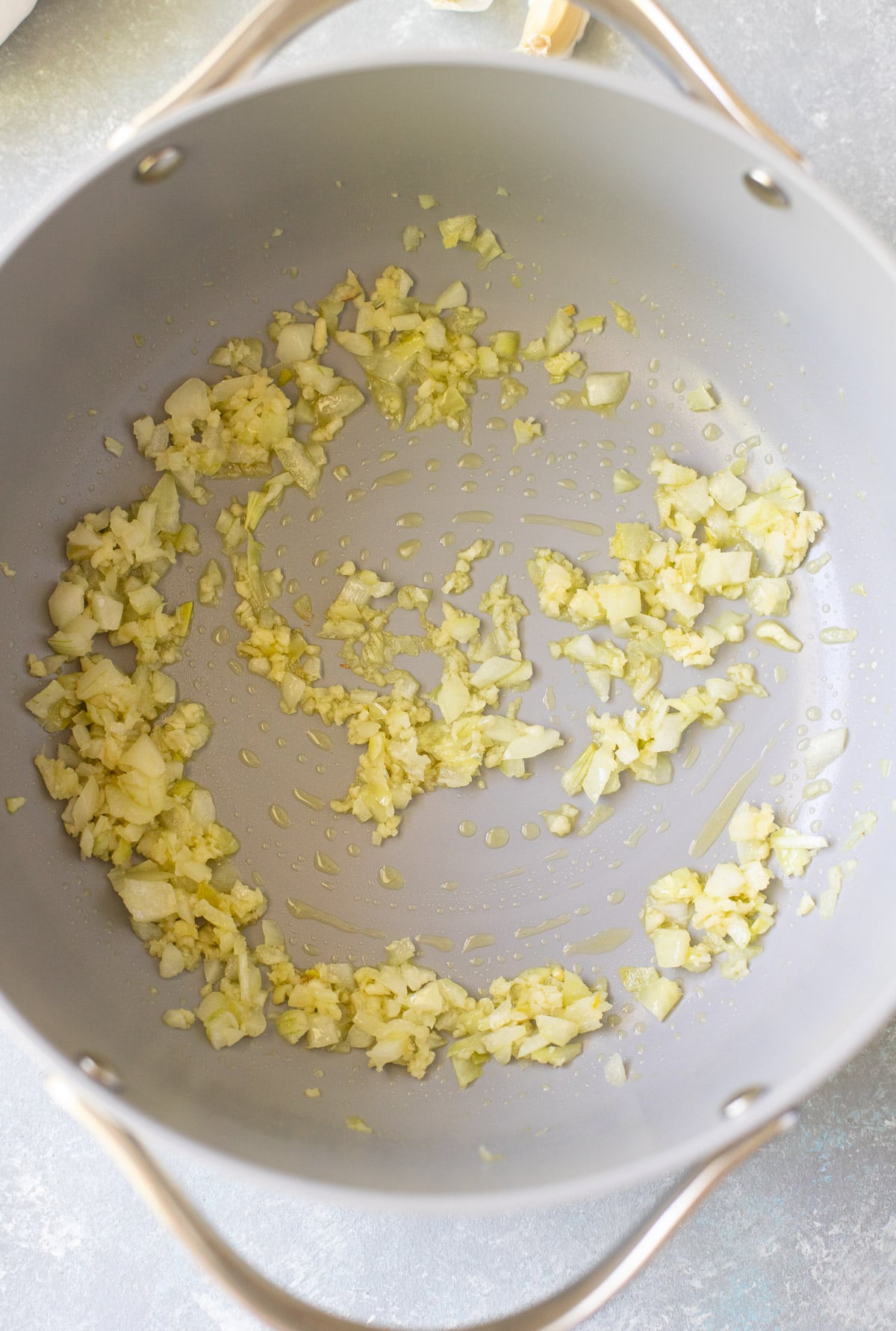 Minced garlic and onion sauteed in a pan for cherry tomato sauce