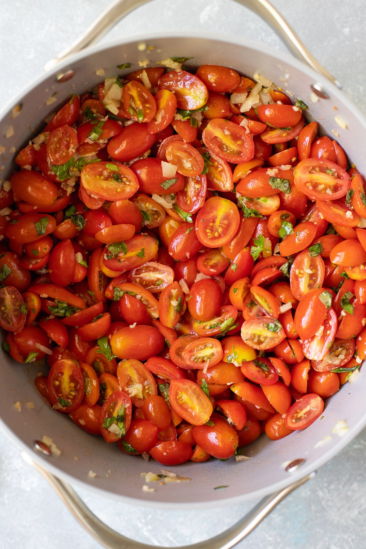 ingredients mixed together for cherry tomato sauce in a pot before being cooked