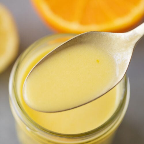 A spoon scooping up a serving of Citrus Dressing