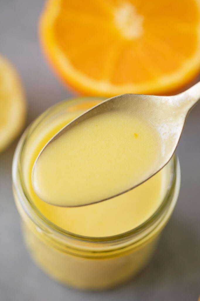 A spoon scooping up a serving of Citrus Dressing