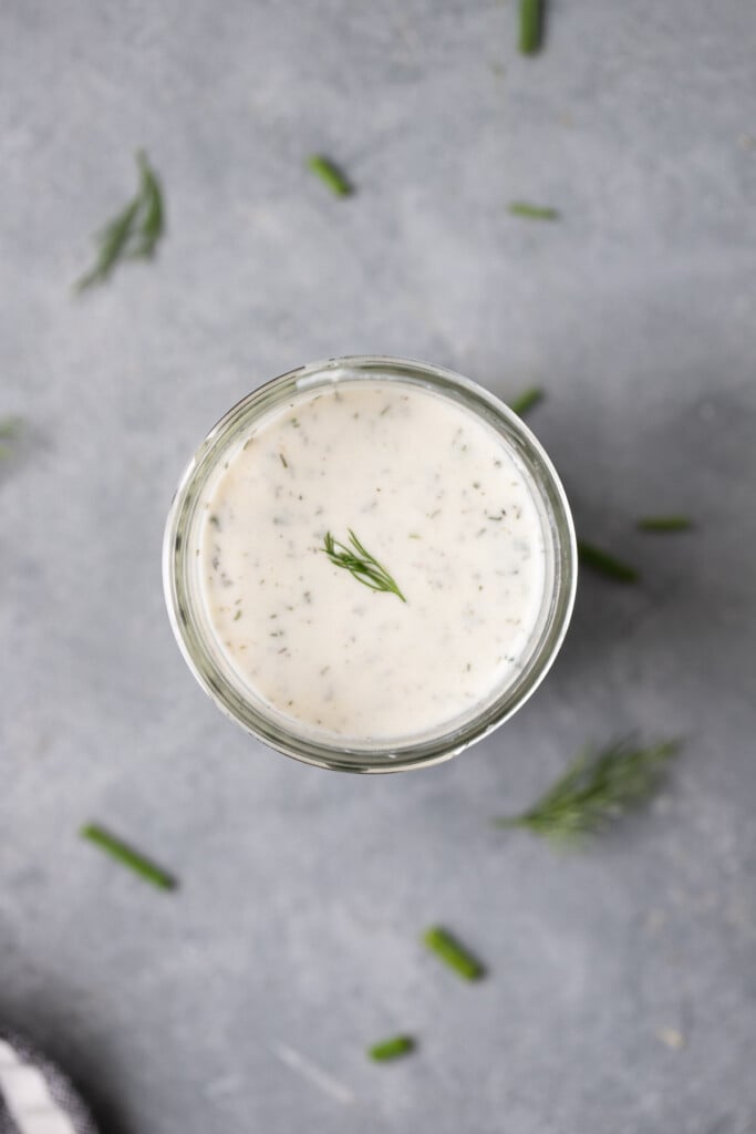 A close up of a mason jar filled with healthy ranch dressing