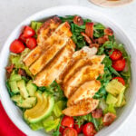 A close up of honey mustard dressing drizzled on a salad