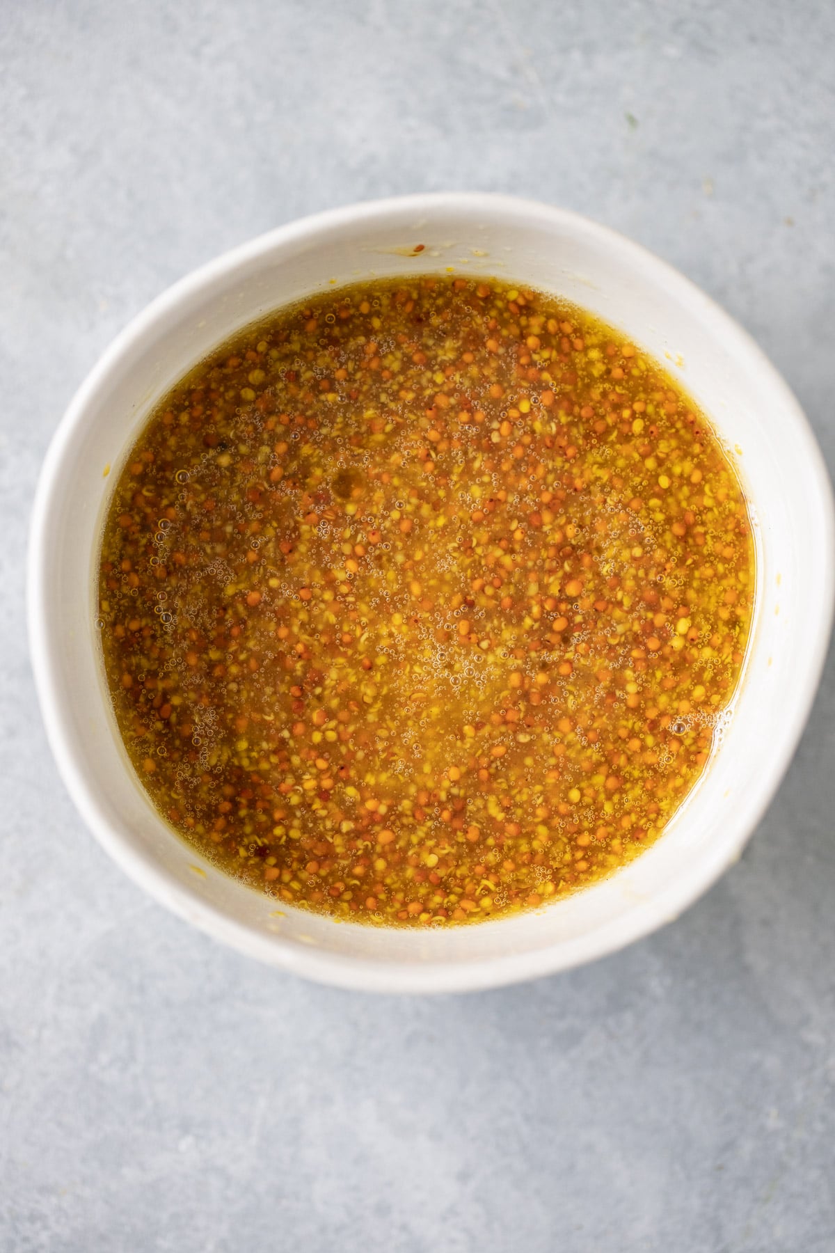 A close up of easy honey mustard dressing in a bowl