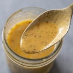 A close up of a spoonful of Italian Dressing from a mason jar