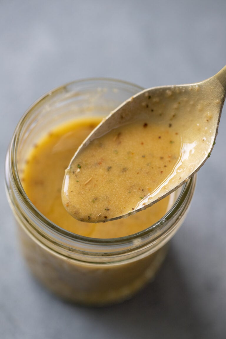 A close up of a spoonful of Italian Dressing from a mason jar