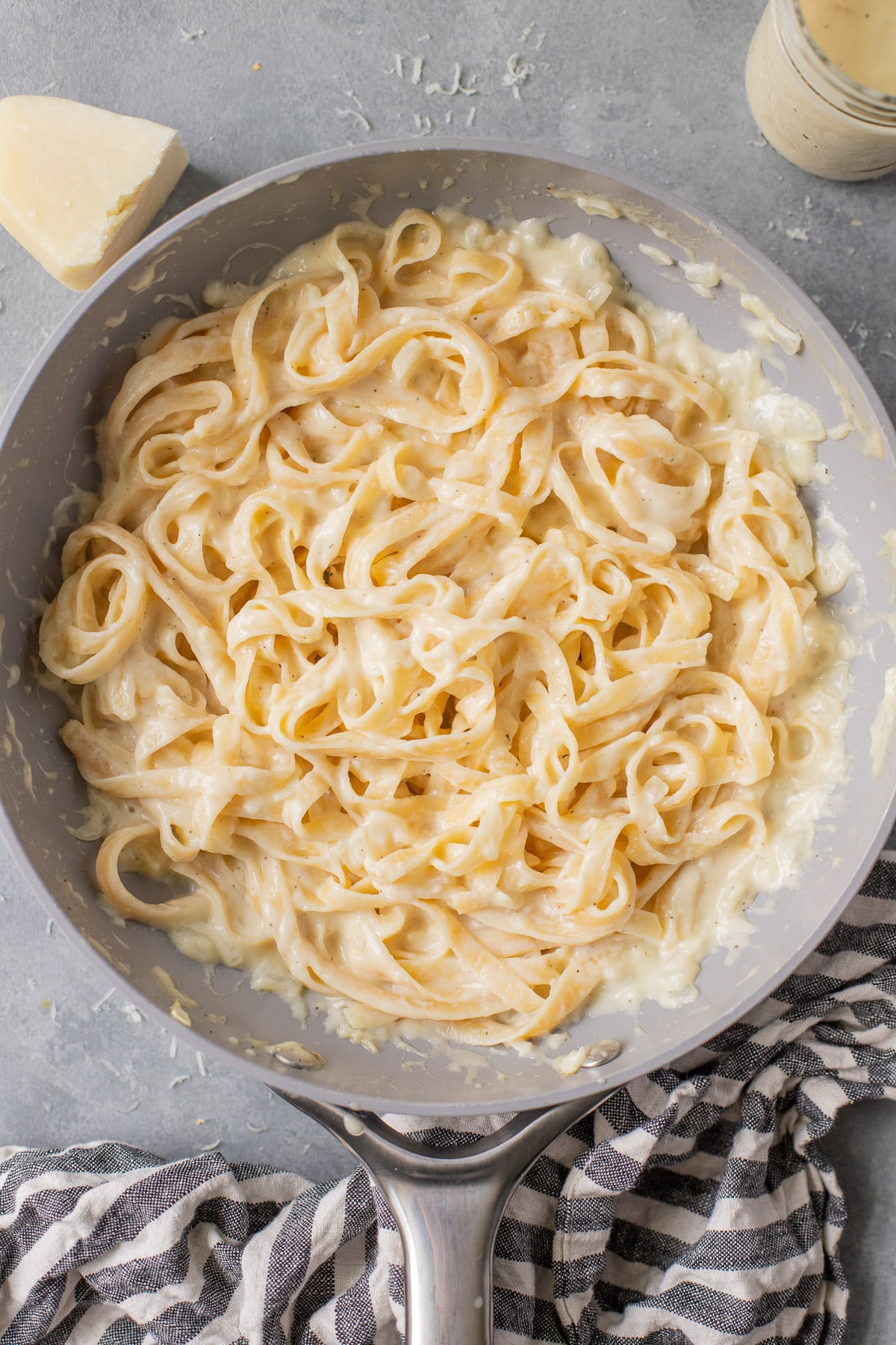 a close up of healthy fettucine alfredo tossed in a pan