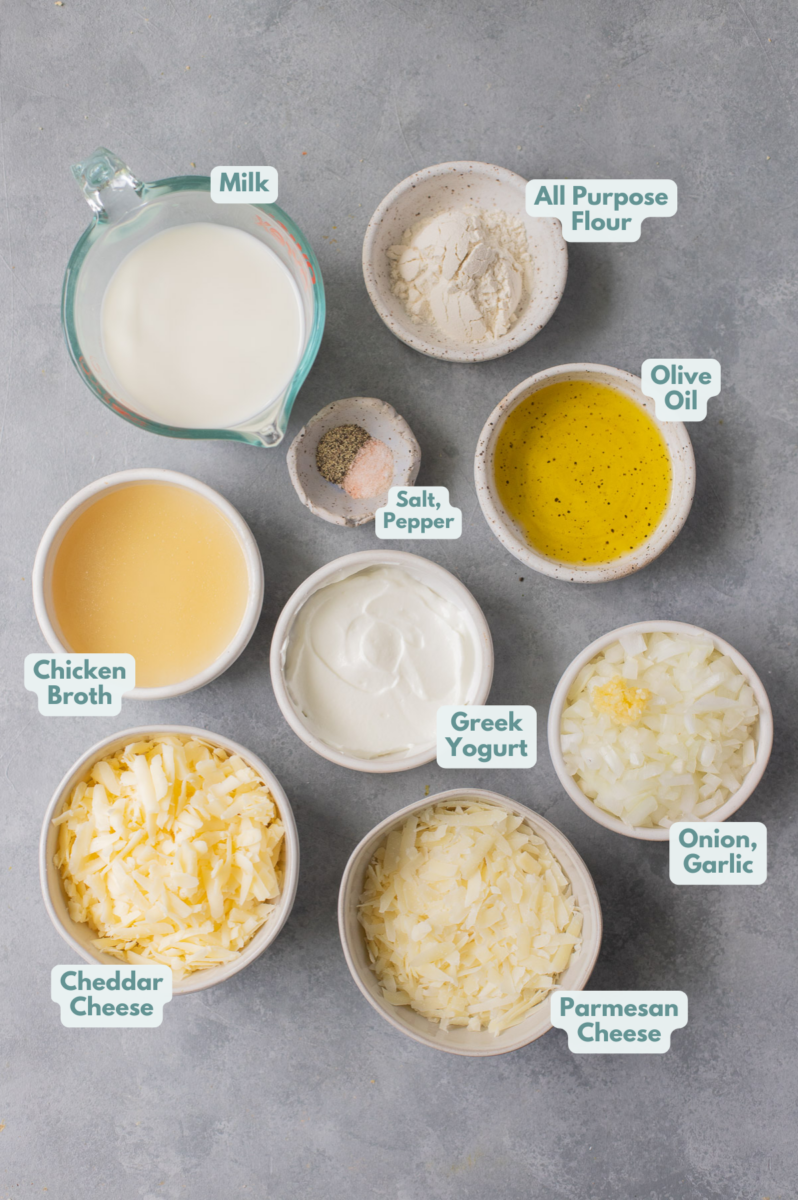 Ingredients for healthier alfredo sauce in small white bowls on a grey background