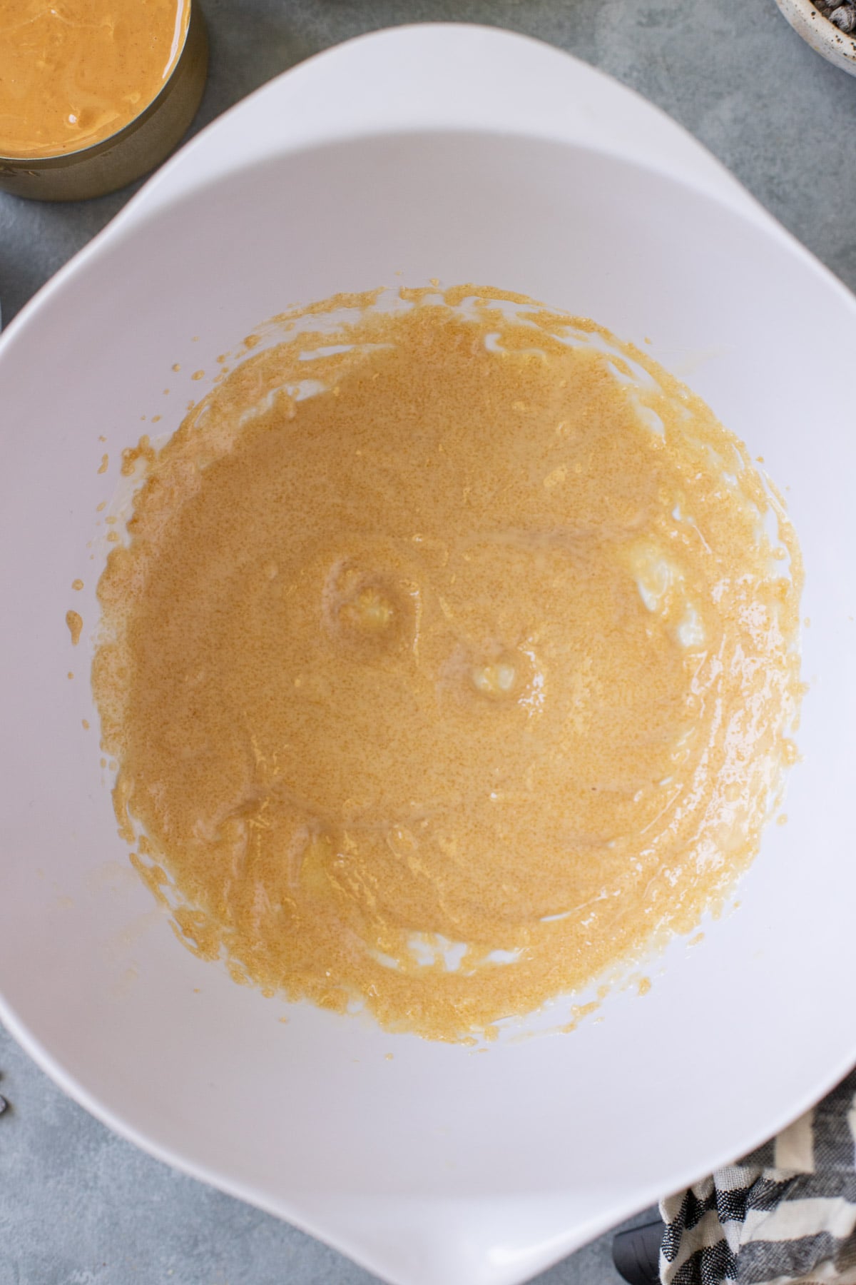 Creamed butter and brown sugar in a white bowl