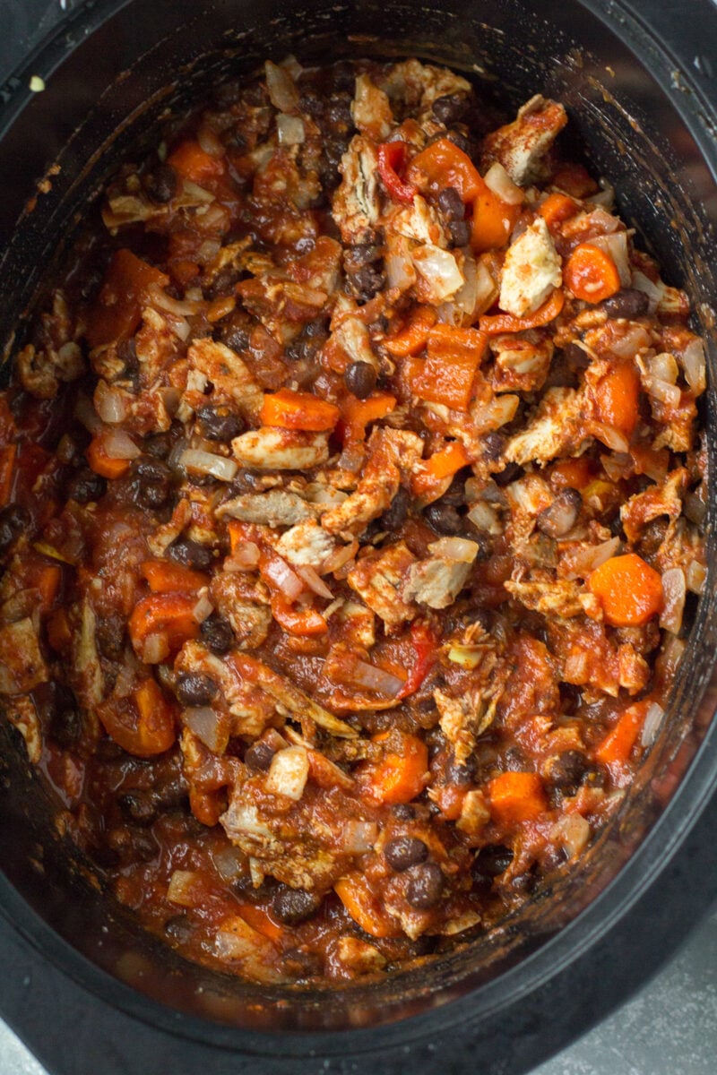 Leftover turkey chili stirred together uncooked in a crockpot base.