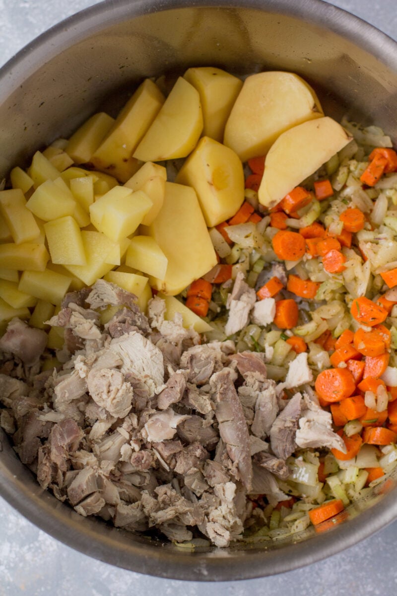 Ingredients for Turkey Pot Pie Soup in an instant pot before mixing together and cooking.