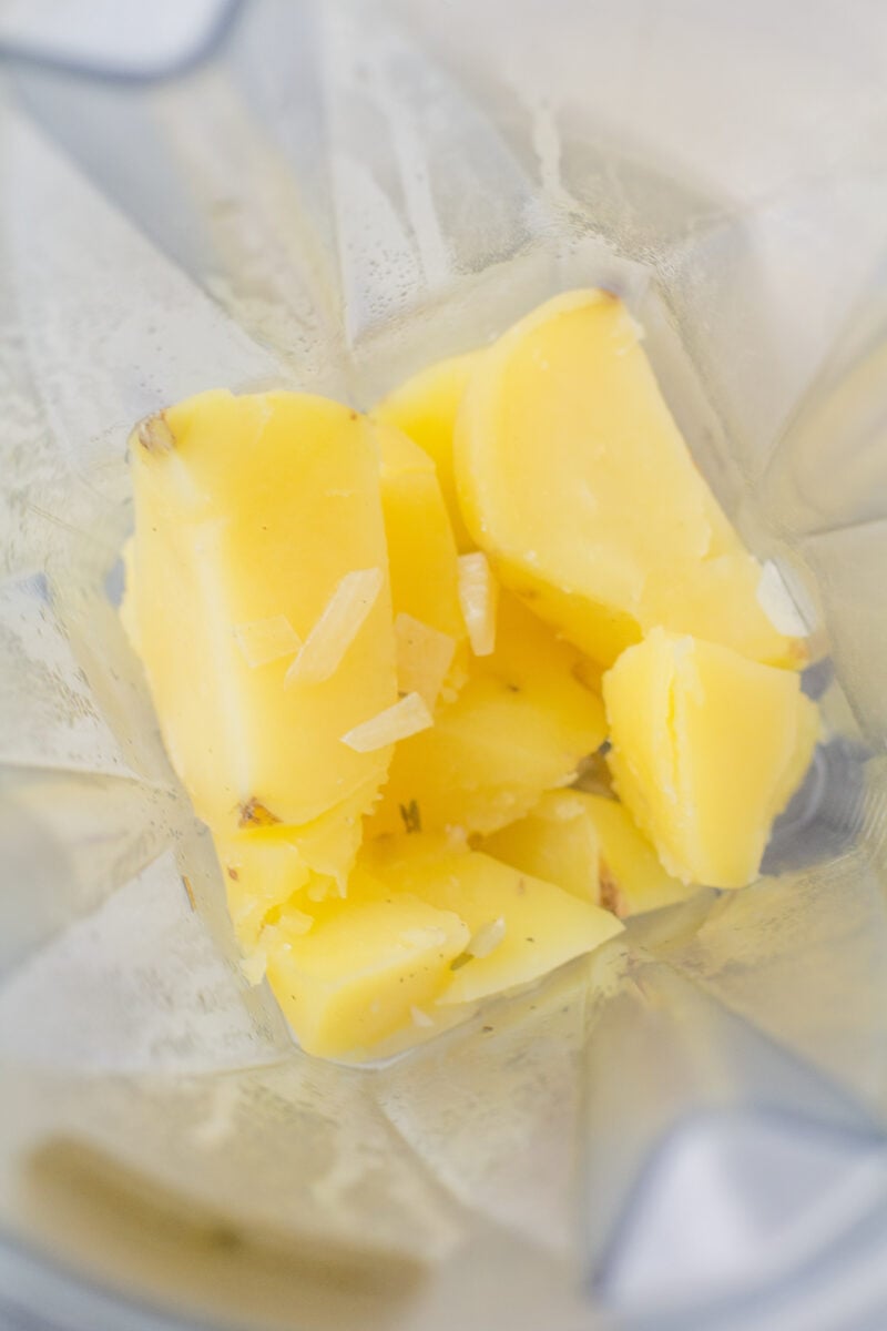 Cooked potato pieces in a blender before blending.