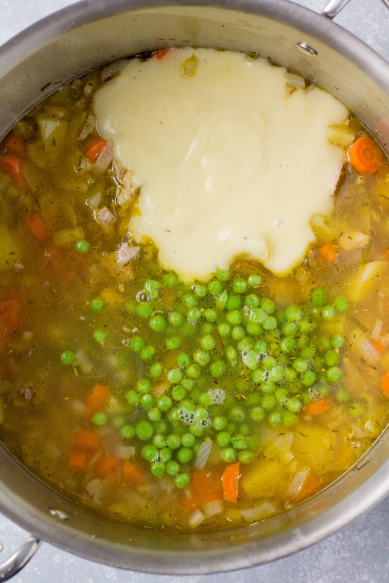 Frozen peas and potato/milk mixture added to turkey pot pie soup in an instant pot, before mixing together.
