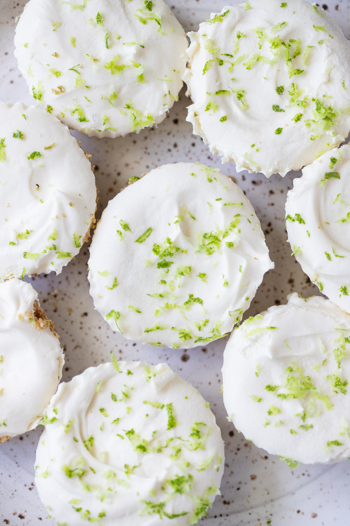 An overhead shot of a plate of mini lime cheesecakes