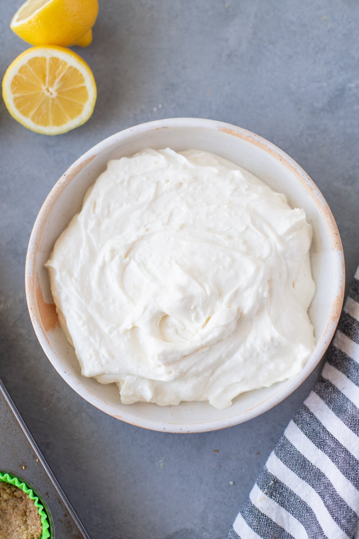 Filling for key lime cheesecakes in a white bowl on a grey background