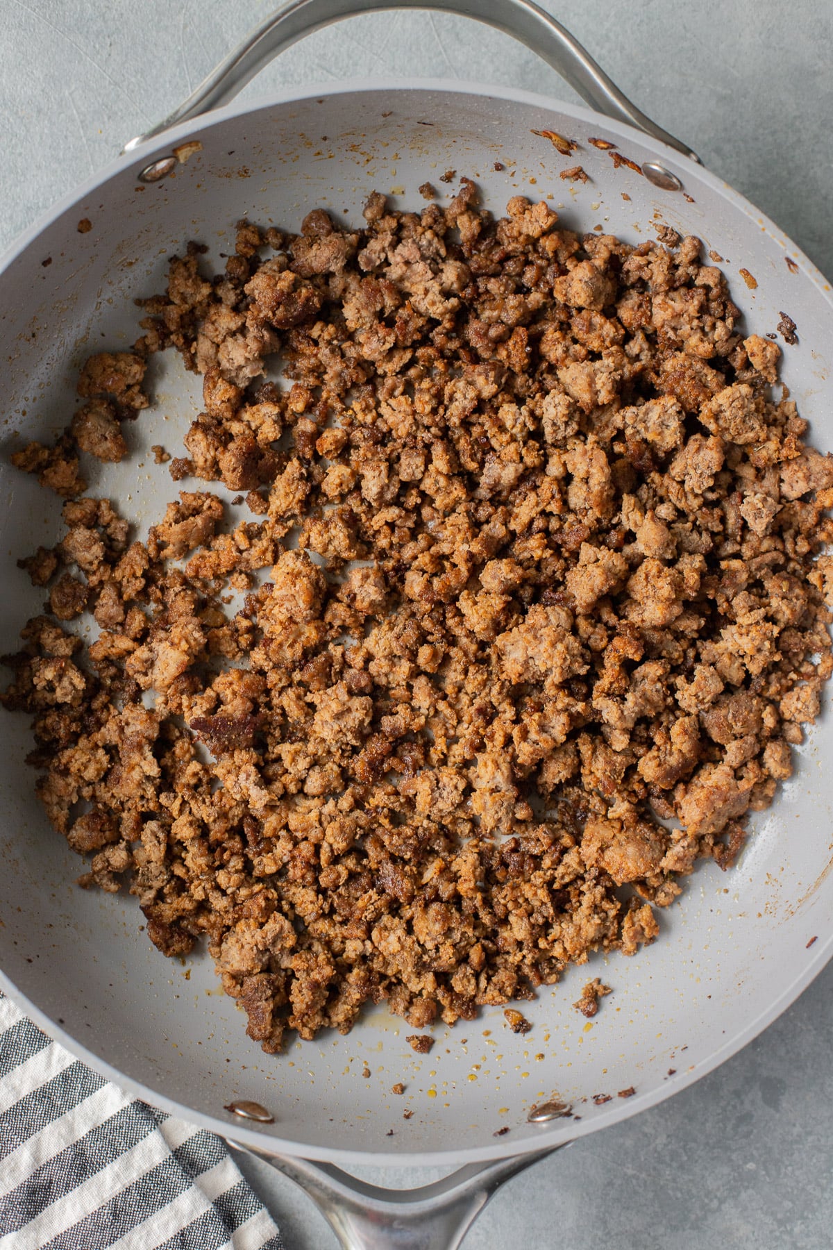 Ground beef browned in a pan with taco seasoning for 7 layer dip