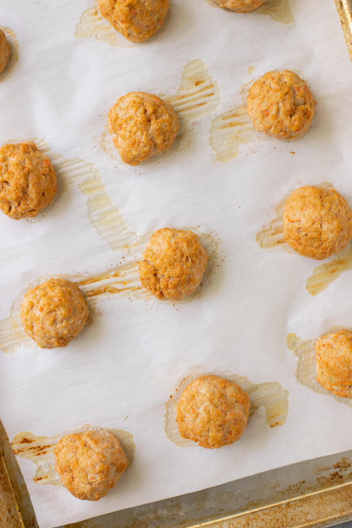 A baking sheet of cooked buffalo chicken meatballs