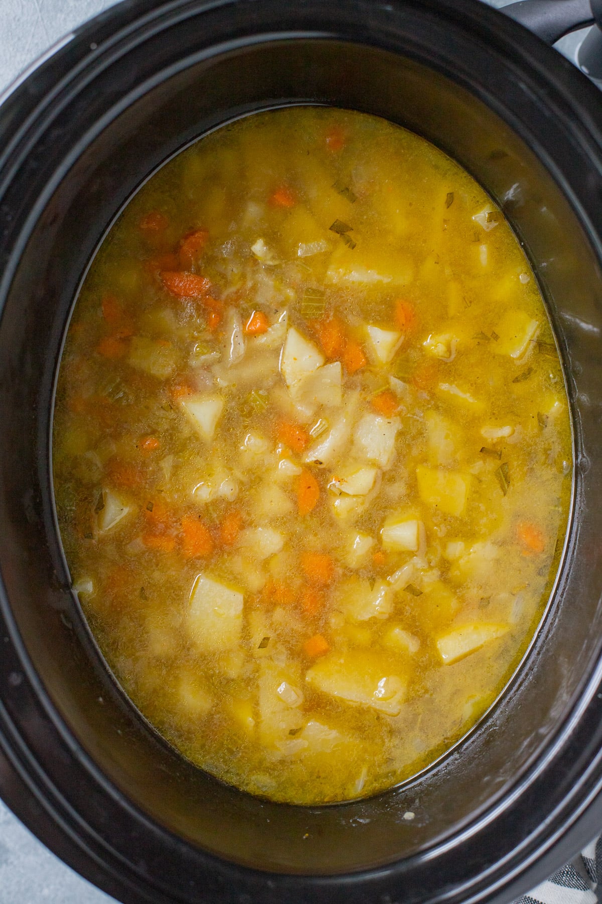 All ingredients for crock pot potato soup in a slow cooker after cooking