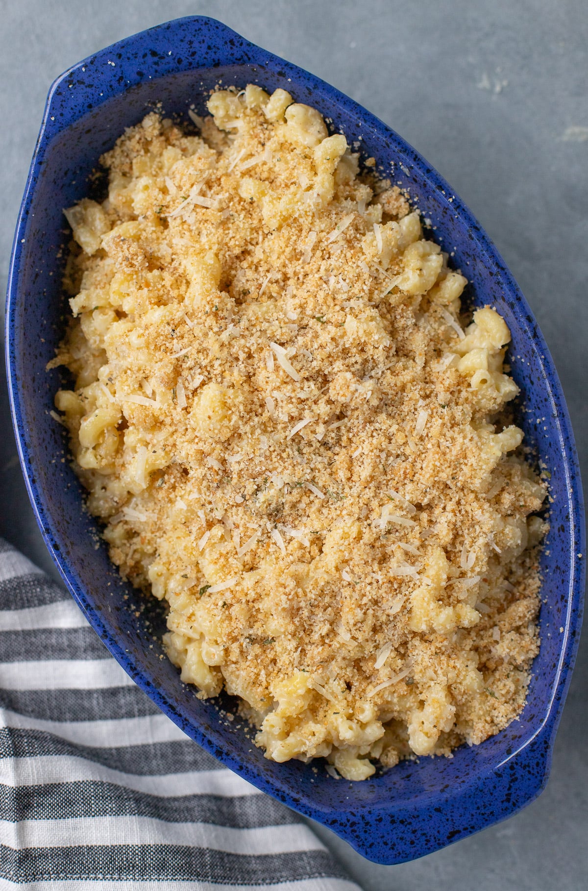 A blue casserole dish with healthy mac and cheese before being baked