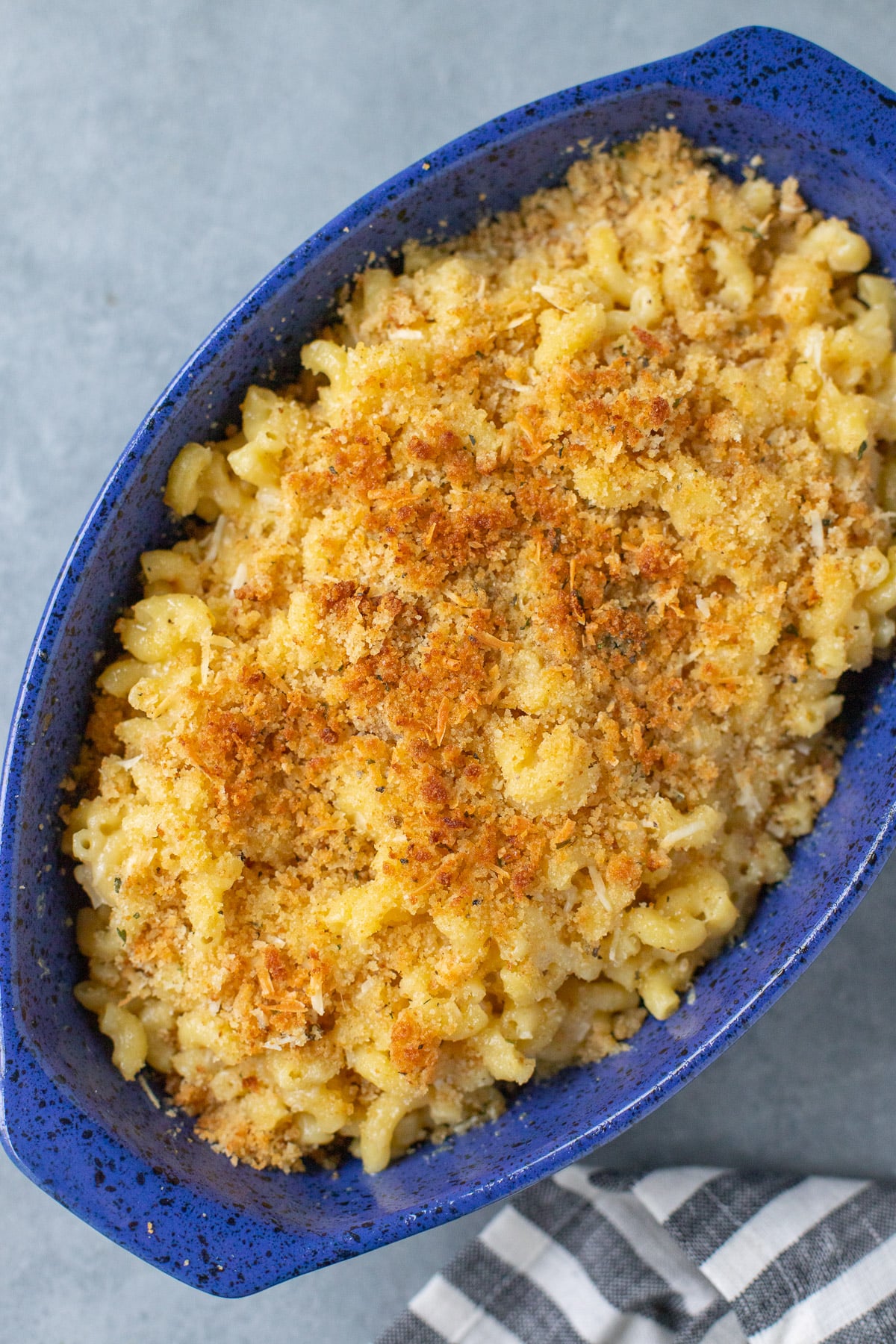 A blue casserole dish with healthy mac and cheese after being baked