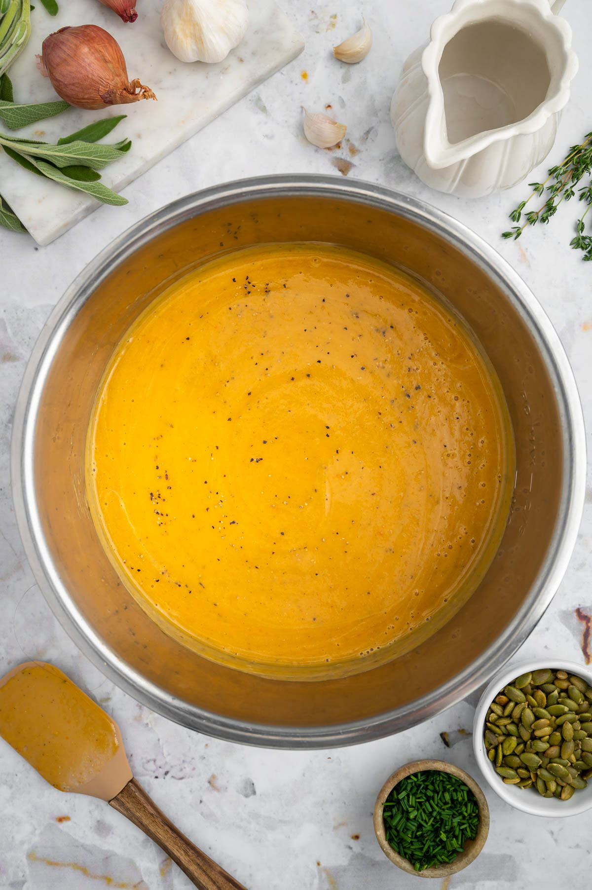 An overhead shot of instant pot butternut squash soup in an instant pot on a white background