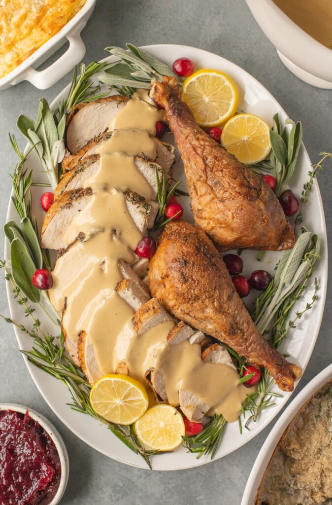 an overhead image of herb butter turkey sliced on a platter