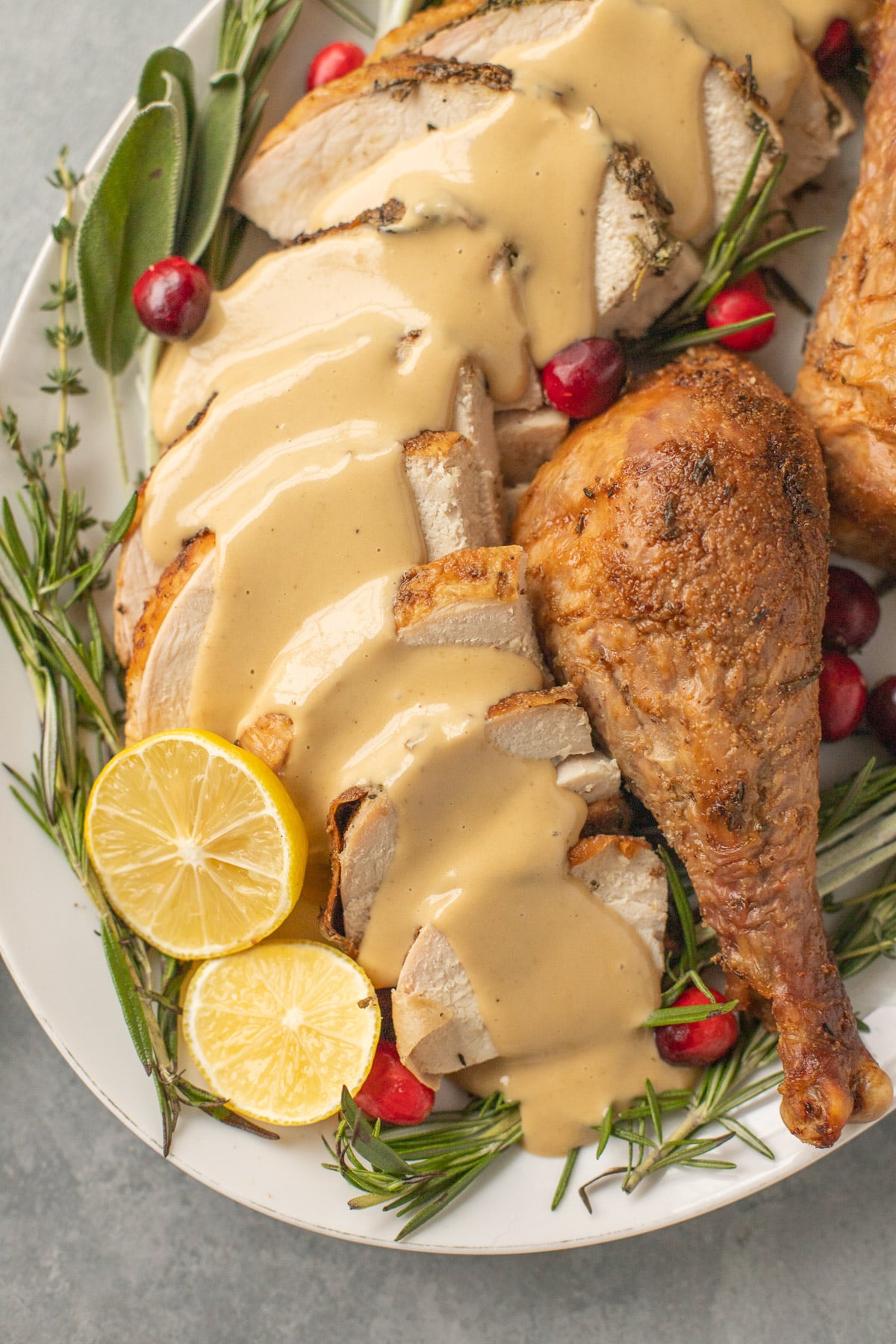 a close up of herb butter turkey coated in gravy