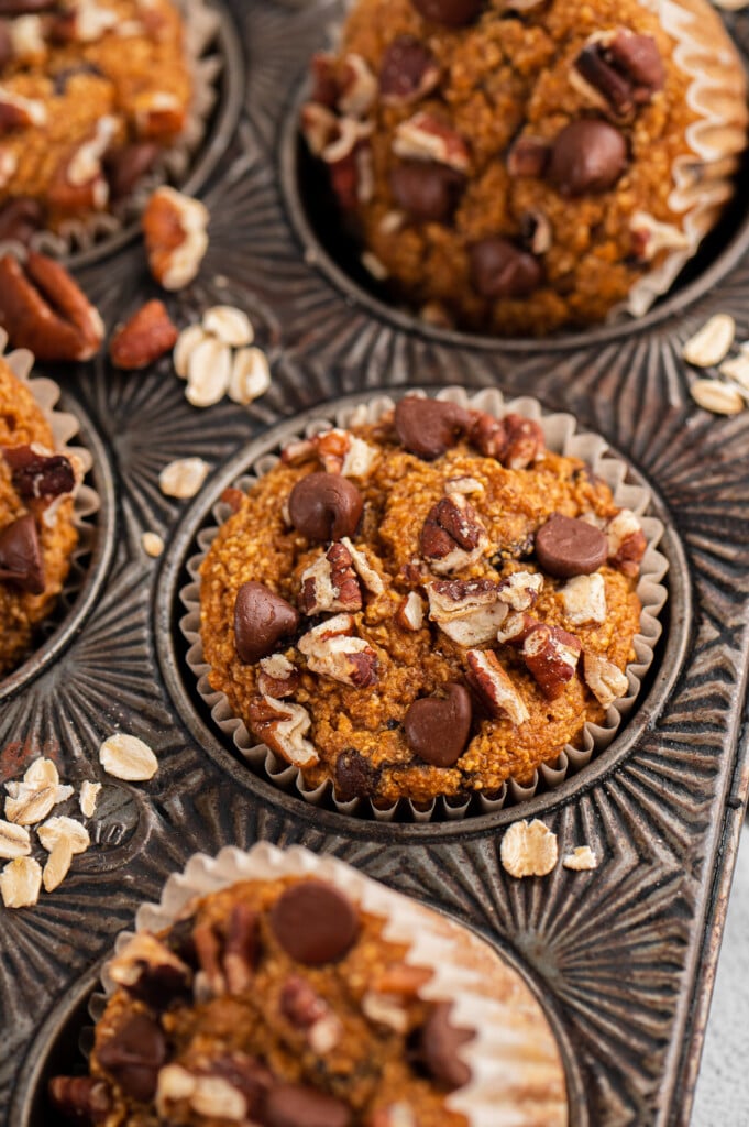 Sweet potato muffins in a muffin tin with chocolate chips on top