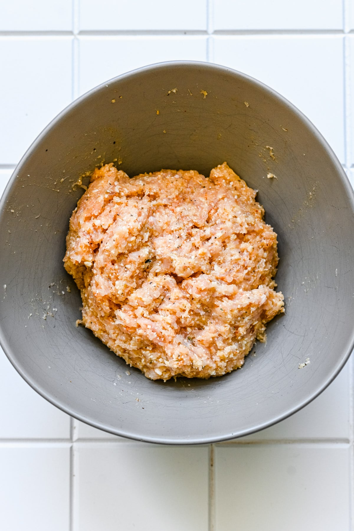 Chicken meatball raw in a grey bowl