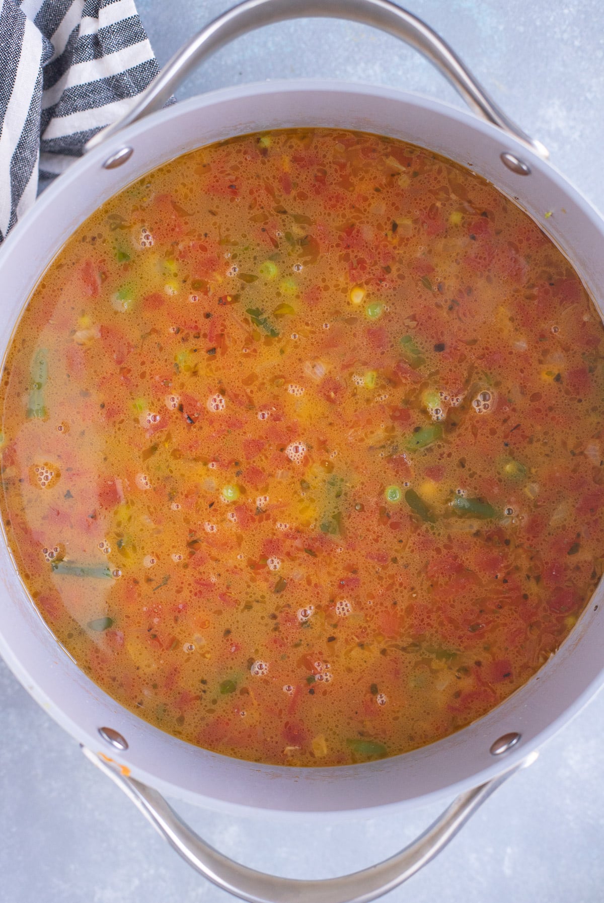 A pot of ground beef vegetable soup before adding noodles