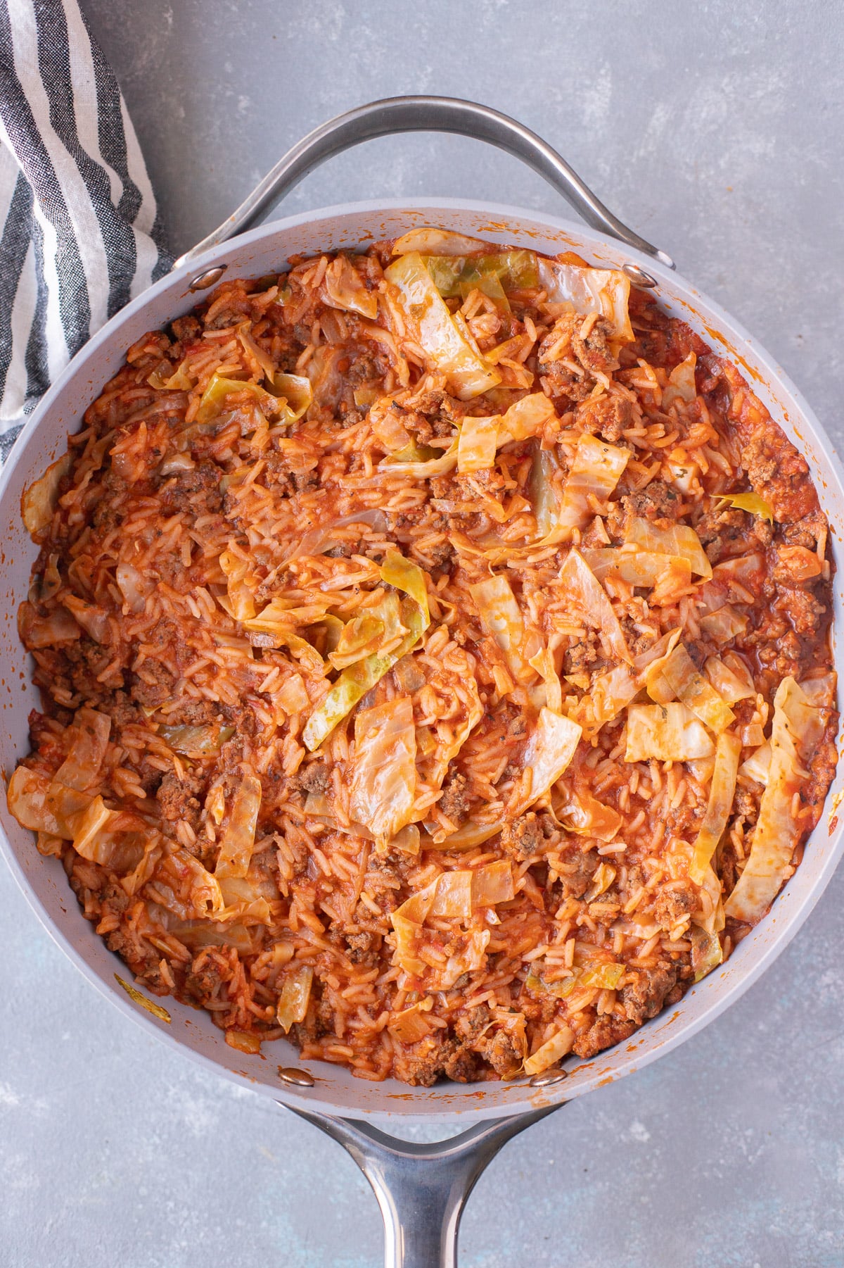 An overhead shot of a pan of unstuffed cabbage rolls before cheese is added