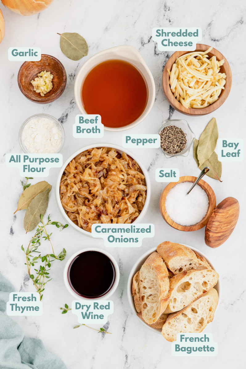 Ingredients for best french onion soup in white bowls: olive oil, onions, white wine, dry red wine, all purpose flour, fresh thyme, bay leaves, garlic, salt, pepper, beef broth, baguette, gruyere or provolone cheese