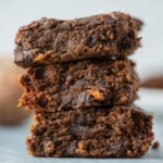 A stack of sweet potato brownies on a grey background