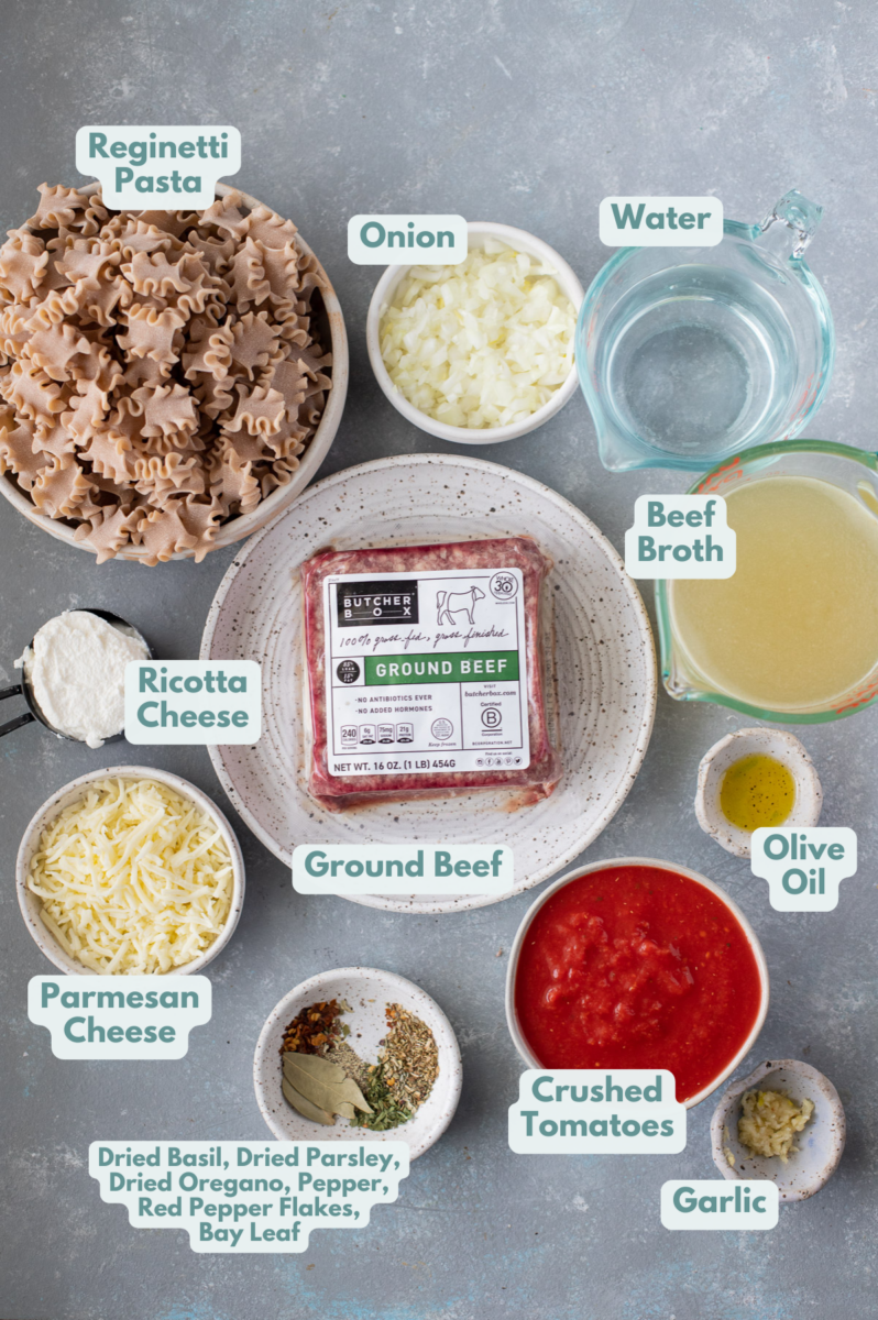 Ingredients for easy lasagna soup in white bowls on a grey background