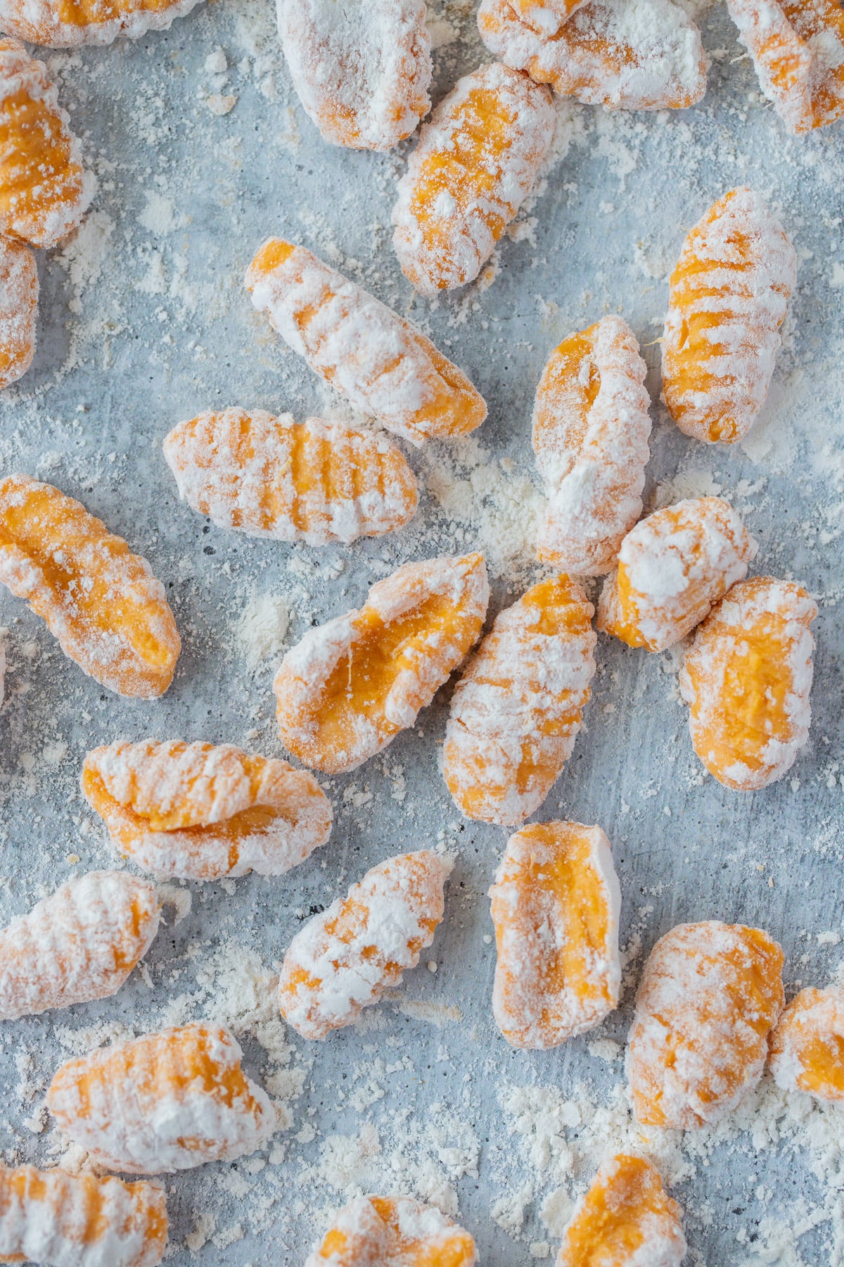 Ridged sweet potato gnocchi on a floured counter