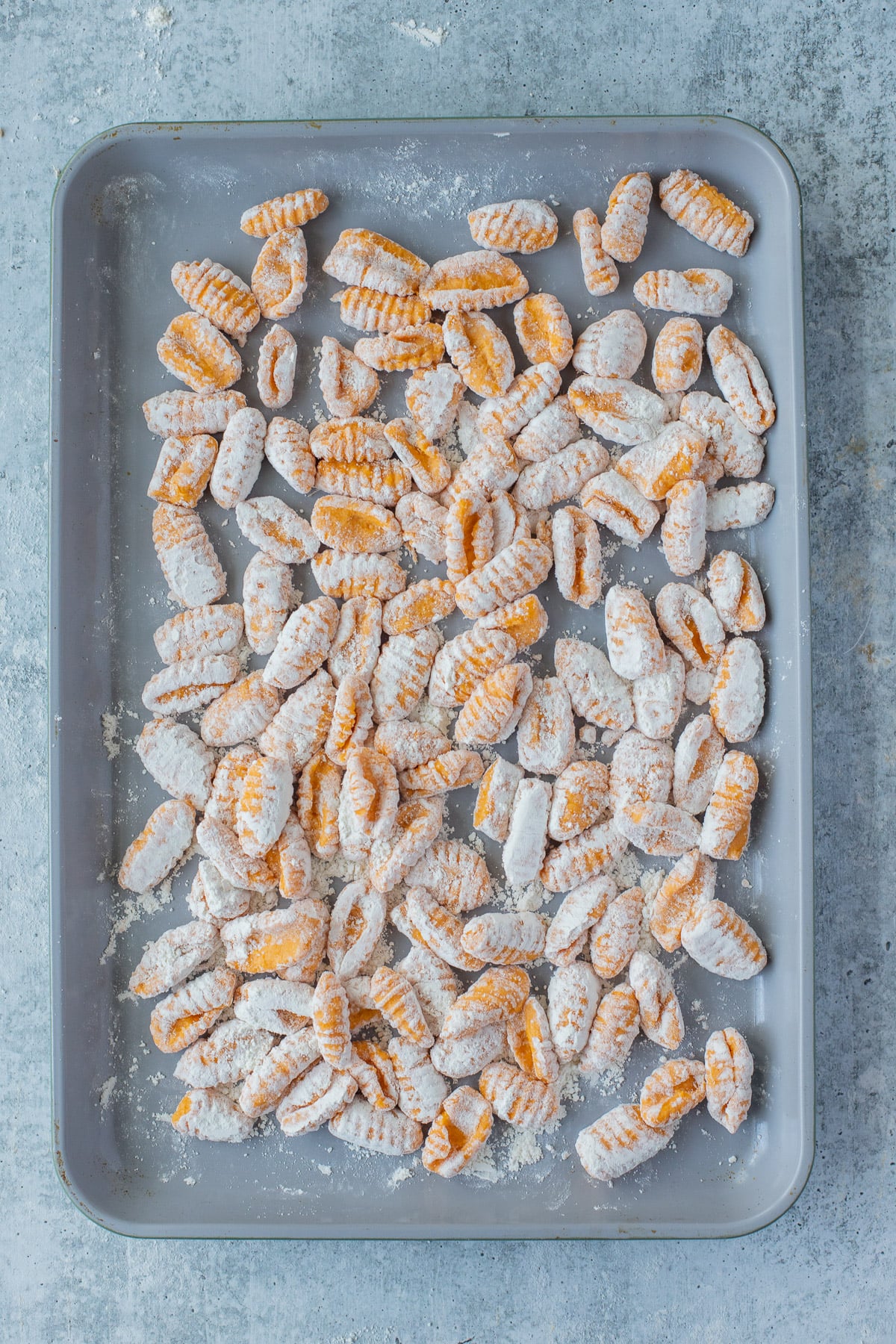 Floured Sweet potato gnocchi on a baking sheet to be frozen