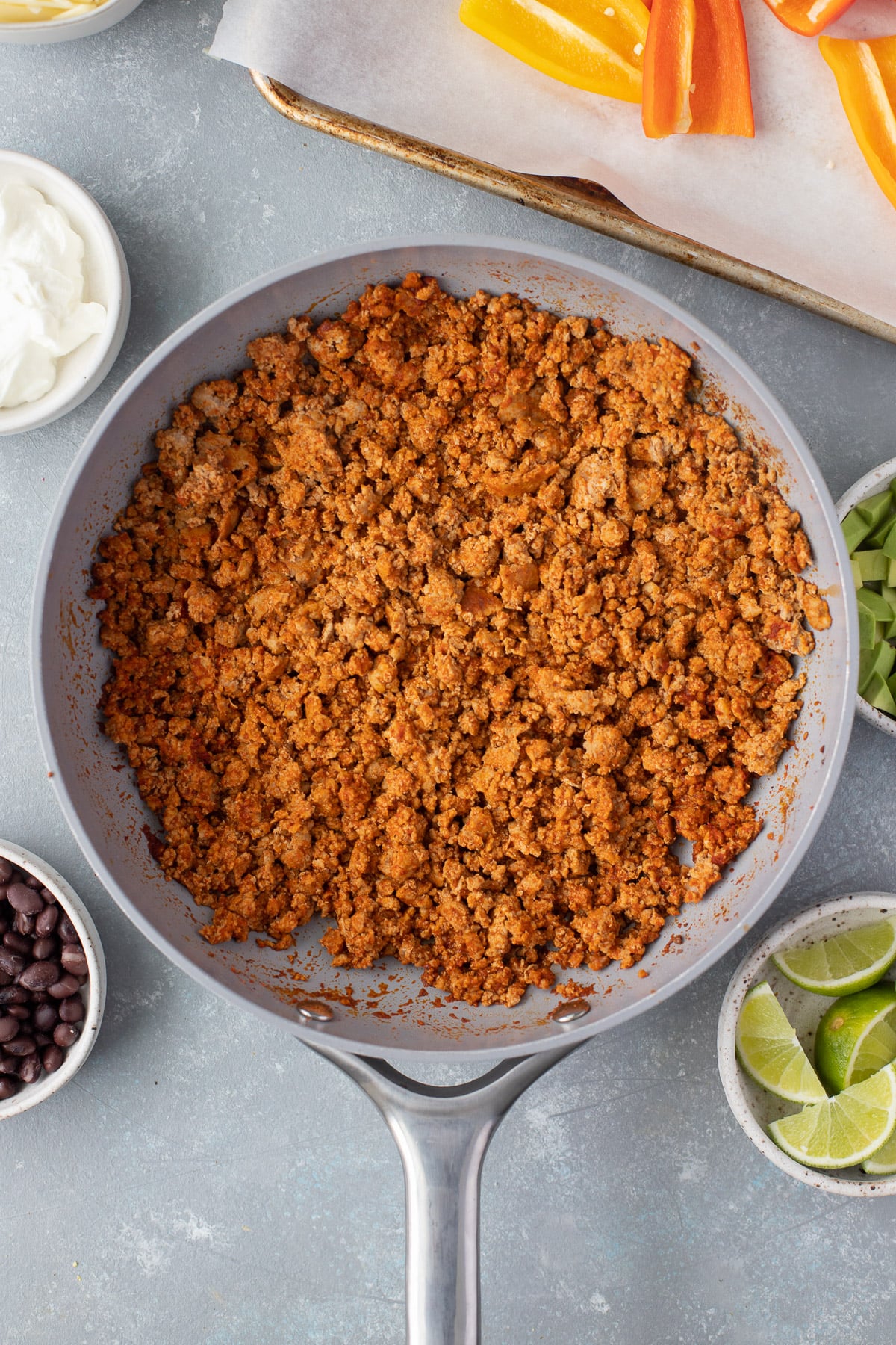 Browned ground turkey with taco seasoning in a pan for bell pepper nachos