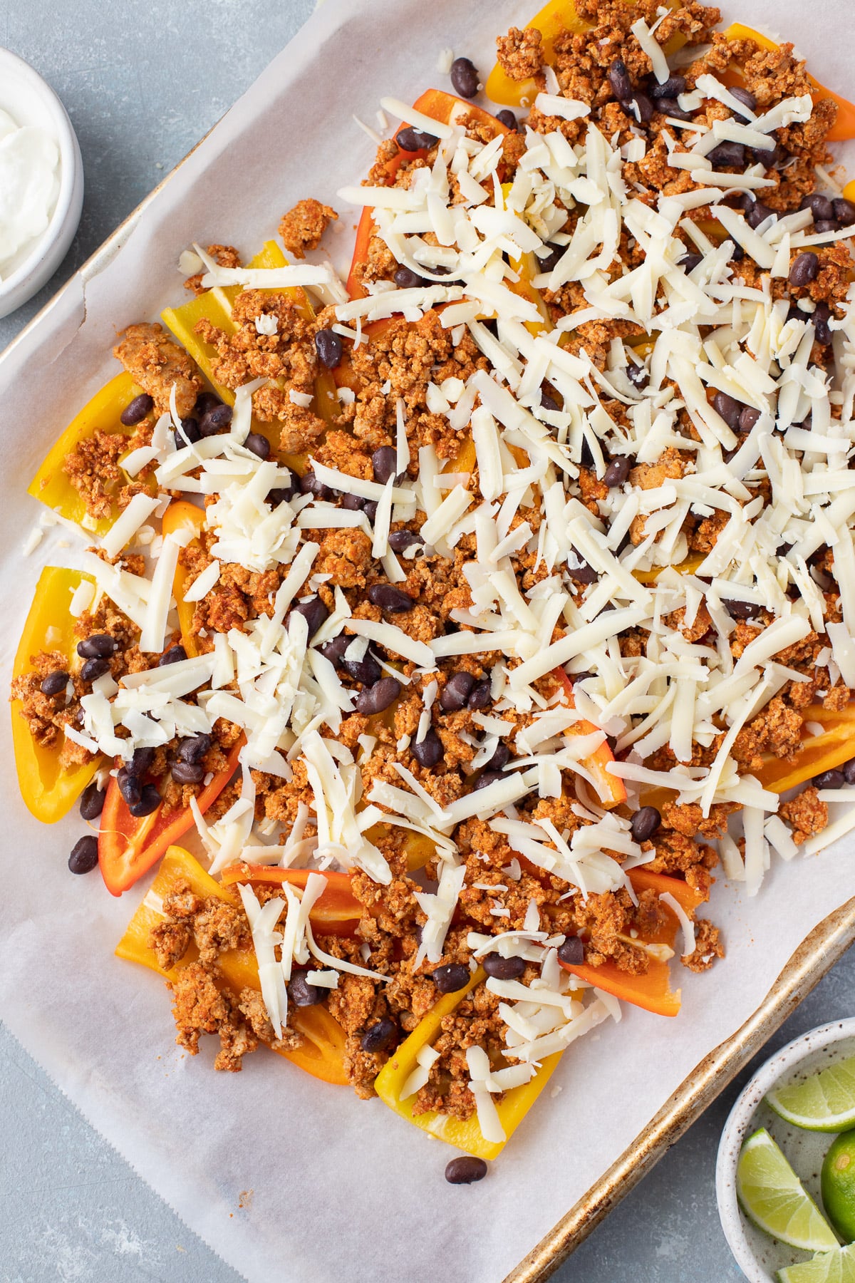 Bell pepper nachos on a sheet pan with ground turkey with taco seasoning, beans, cheese