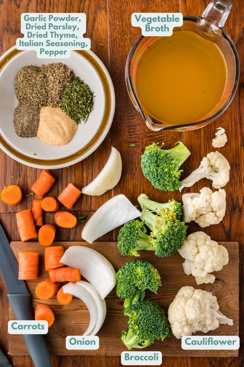 Ingredients for creamy vegetable soup in white bowls: yellow onion, cauliflower florets, broccoli florets, carrots, frozen corn, vegetable broth, dried garlic, dried thyme, dried parsley, italian seasoning, black pepper