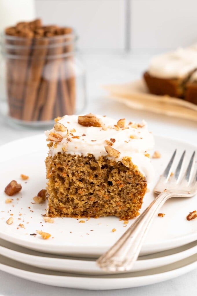 A plated slice of healthy carrot cake with low fat cream cheese frosting.