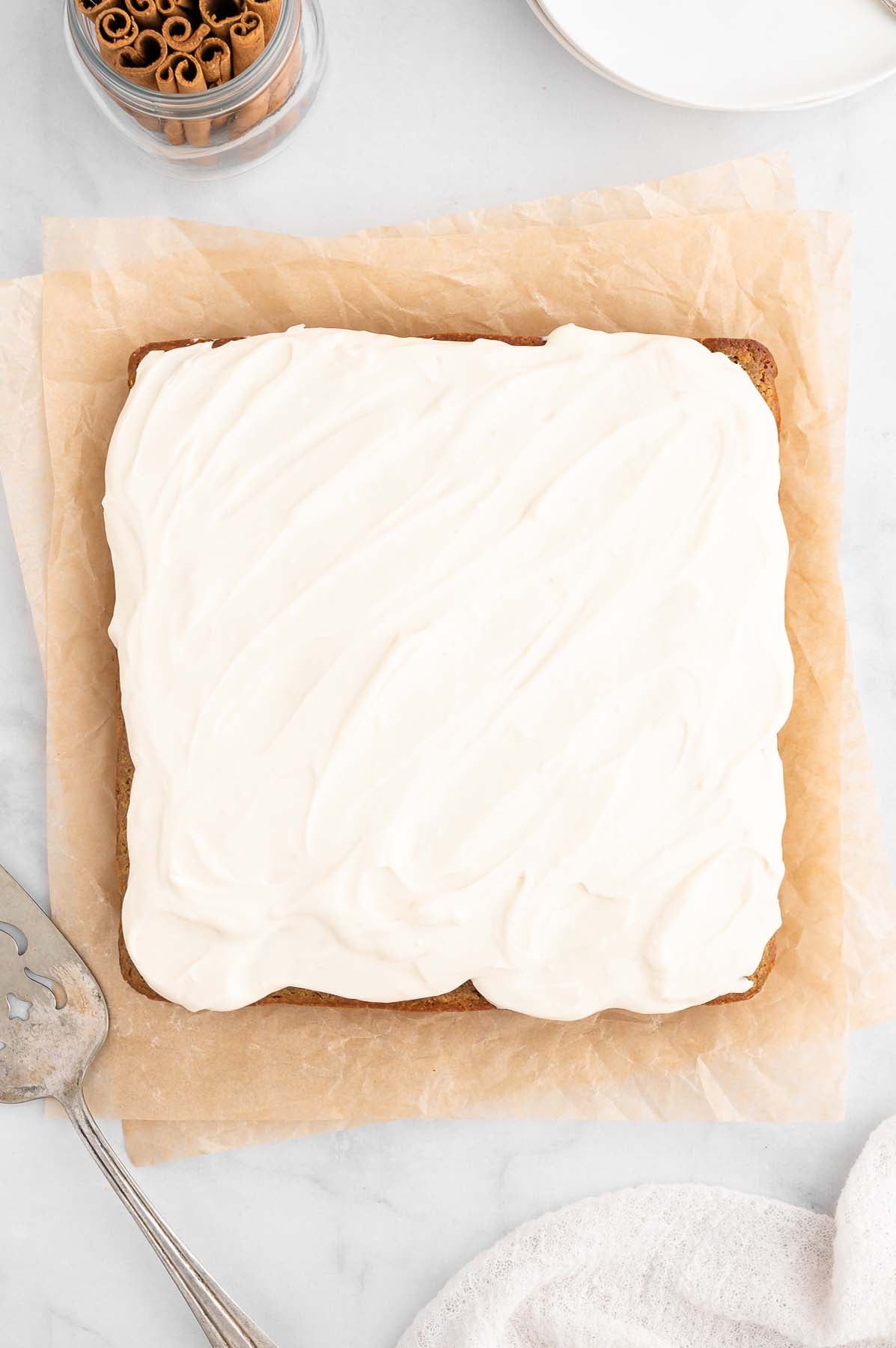 Overhead shot of frosted healthy carrot cake with cream cheese frosting.