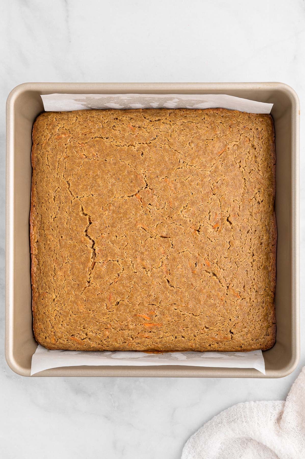 Healthy carrot cake in an 8x8-inch baking pan, right after baking