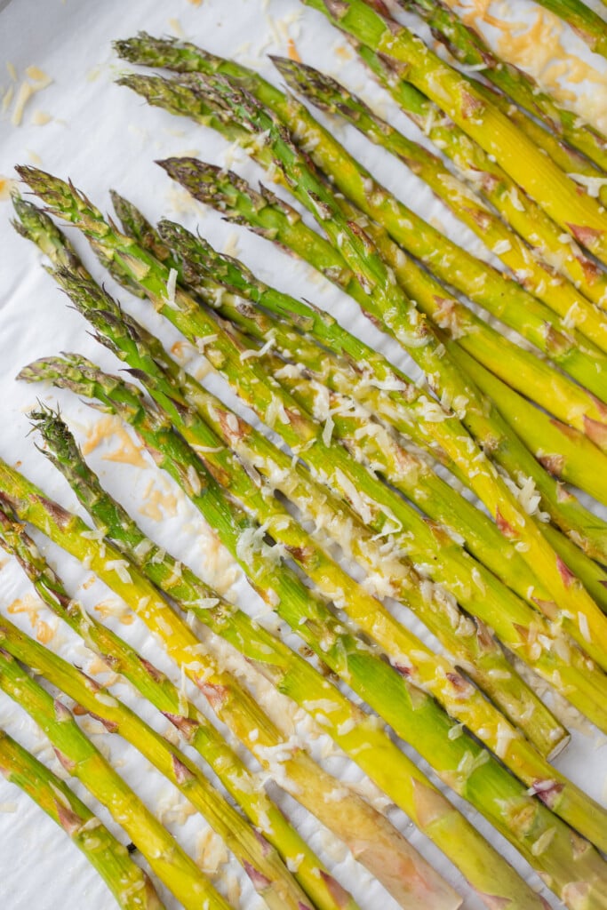 Healthy Lemon Parmesan Roasted Asparagus on a parchment lined baking sheet