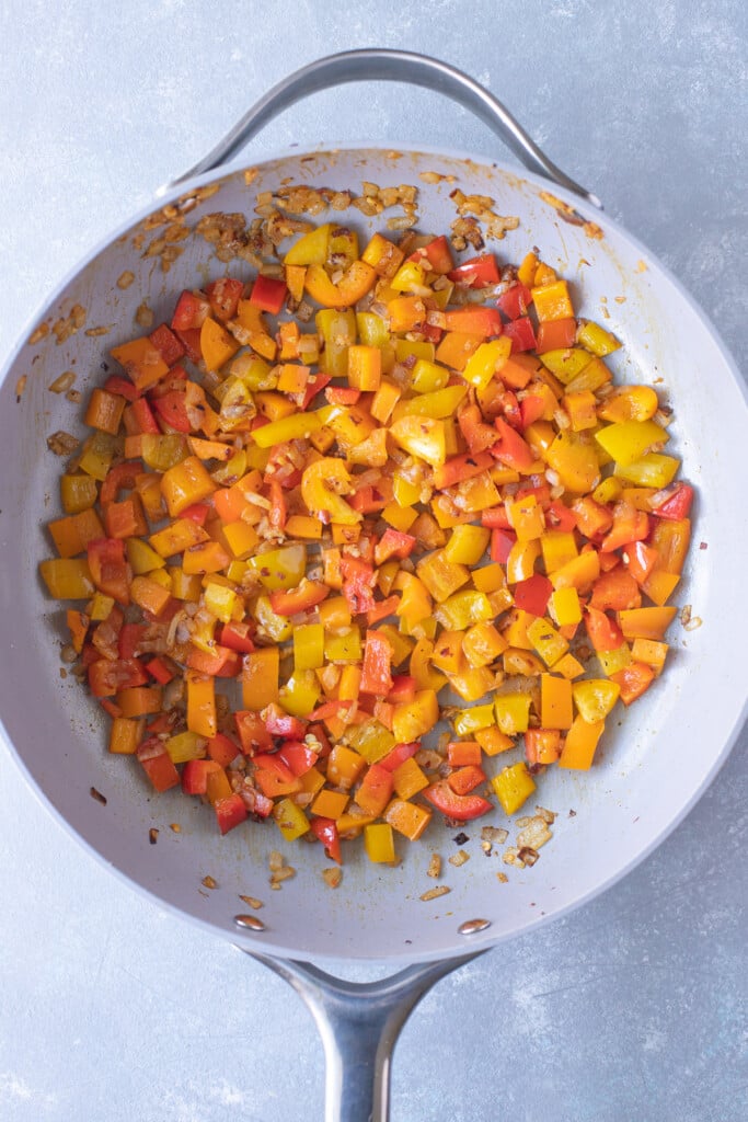 Onions, peppers, and spices cooked in sausage oil after cooking until soft