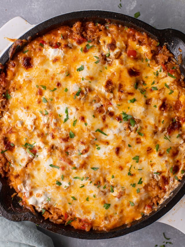 An overhead shot of unstuffed peppers skillet on a grey background