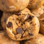 a peanut butter oatmeal ball with a bite taken out of it surrounded by more energy balls