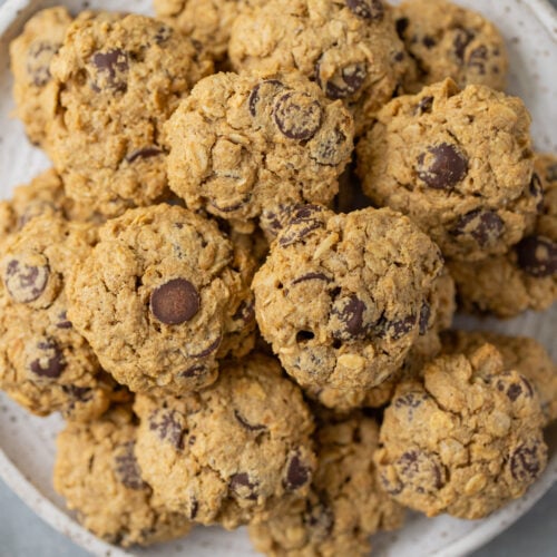 Healthy Oatmeal Chocolate Chip Cookies on a white plate on a grey counter