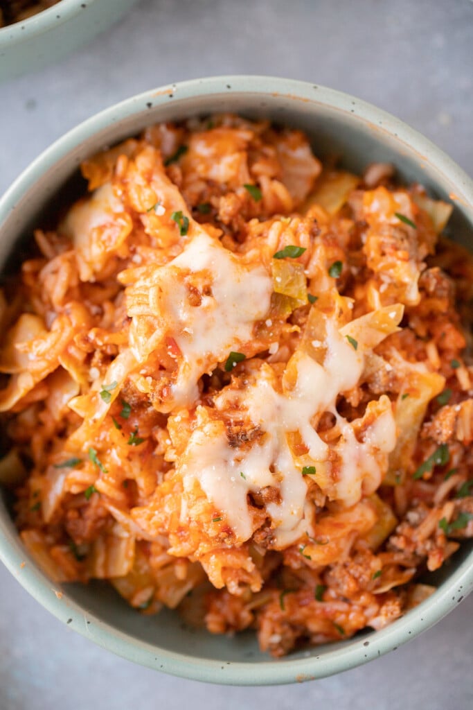 An overhead shot of an unstuffed cabbage rolls recipe in a bowl on a grey background for one pot meals