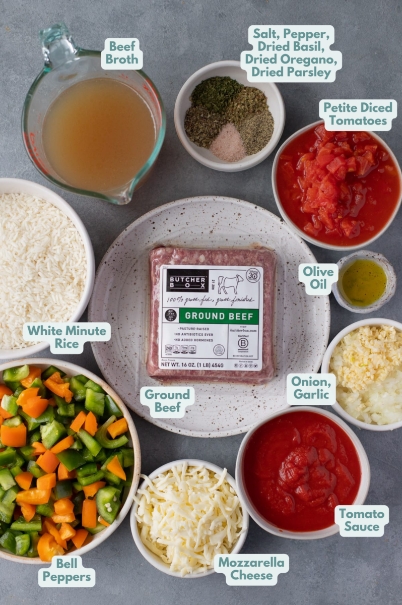 Ingredients for stuffed pepper casserole in whole bowls: olive oil, onion, garlic, diced bell peppers, ground beef, canned tomato sauce, petite diced tomatoes, salt, pepper, dried basil, dried oregano, dried parsley, white minute rice, beef broth, mozzarella cheese